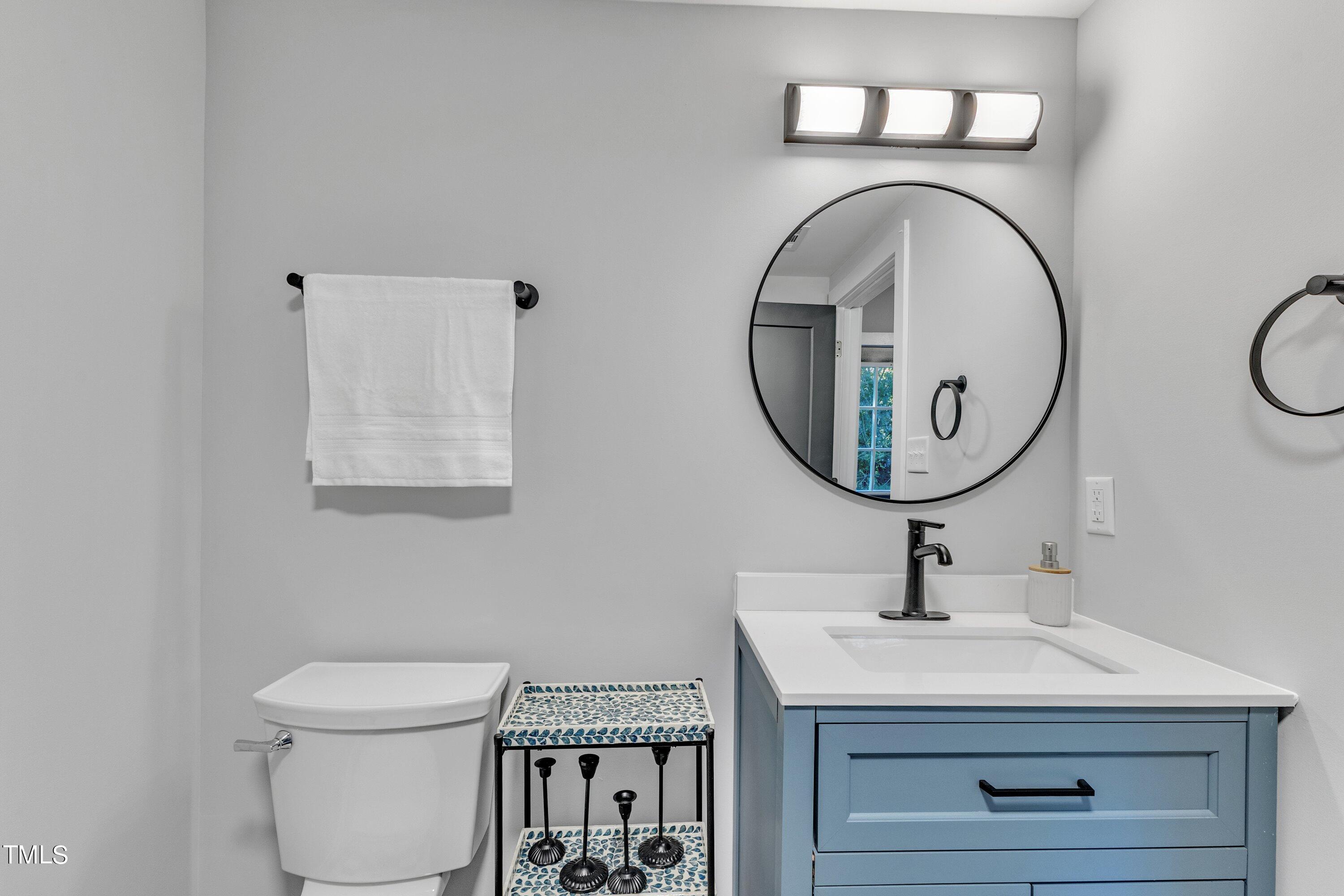712 Bailey Drive Raleigh, NC 27610 - Photo 15 of 33 a bathroom with a toilet a sink and a mirror