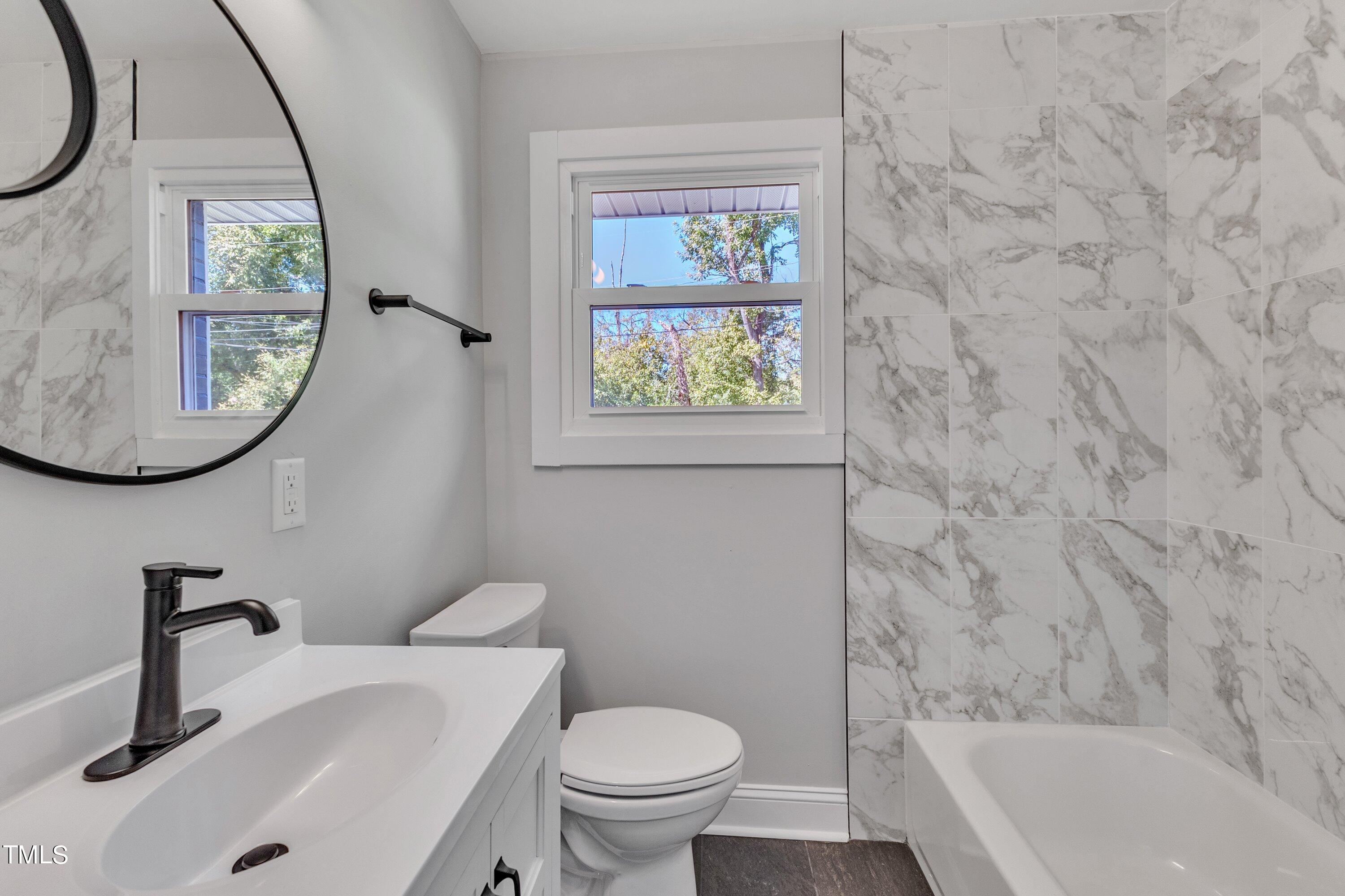 712 Bailey Drive Raleigh, NC 27610 - Photo 17 of 33 a bathroom with a sink a toilet and a tub