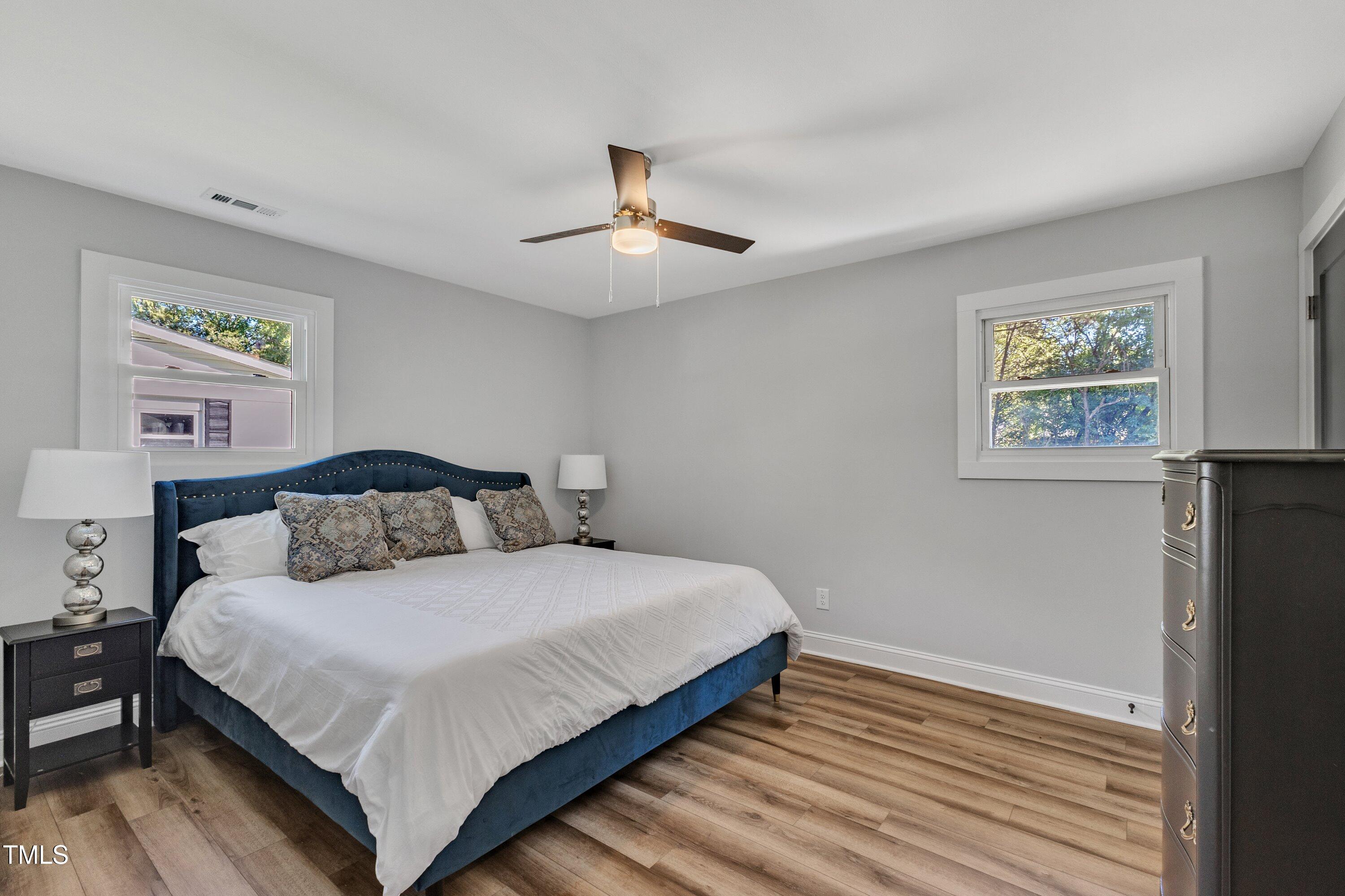 712 Bailey Drive Raleigh, NC 27610 - Photo 18 of 33 a bedroom with a bed and a chandelier