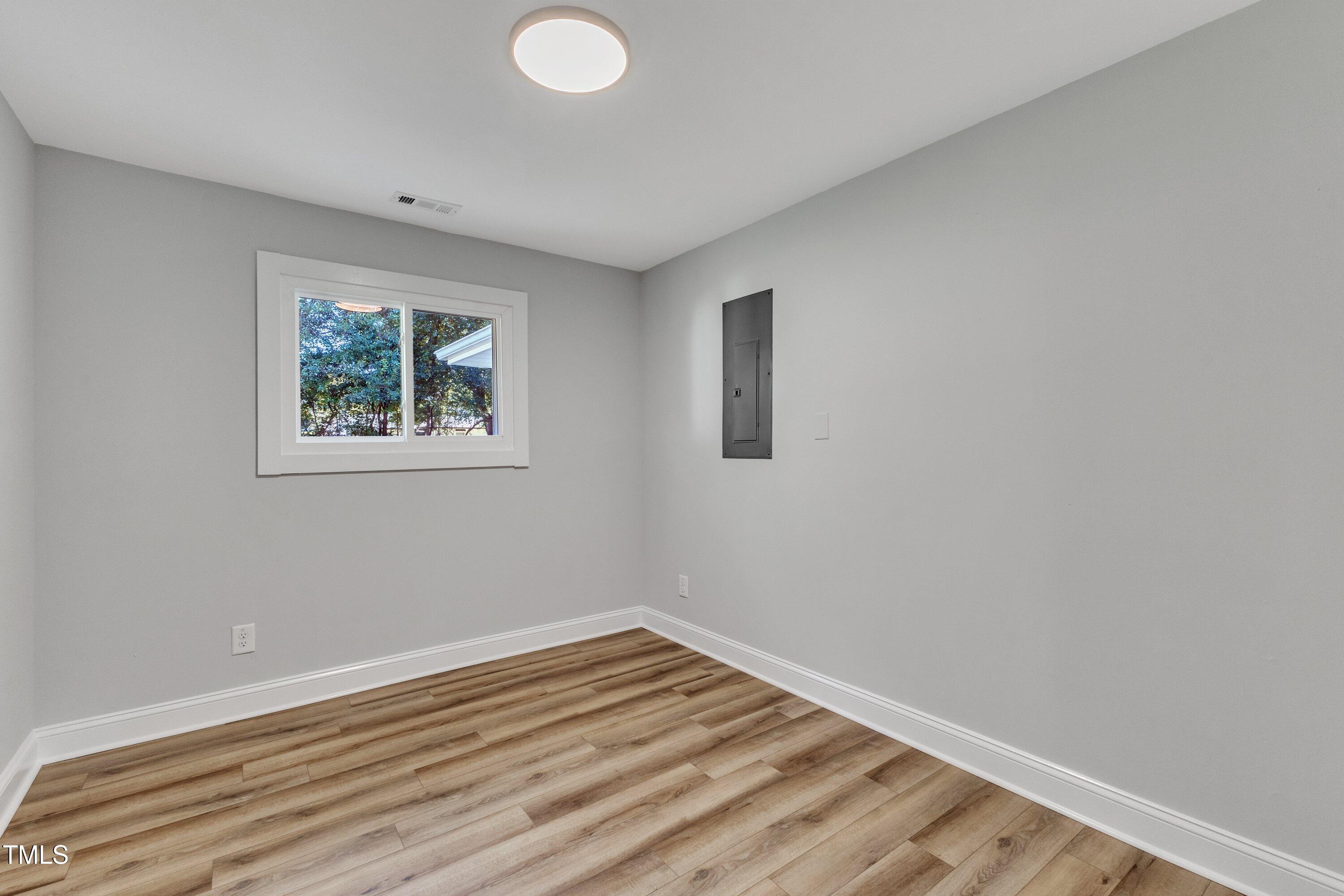 712 Bailey Drive Raleigh, NC 27610 - Photo 22 of 33 a view of room with window and wooden floor