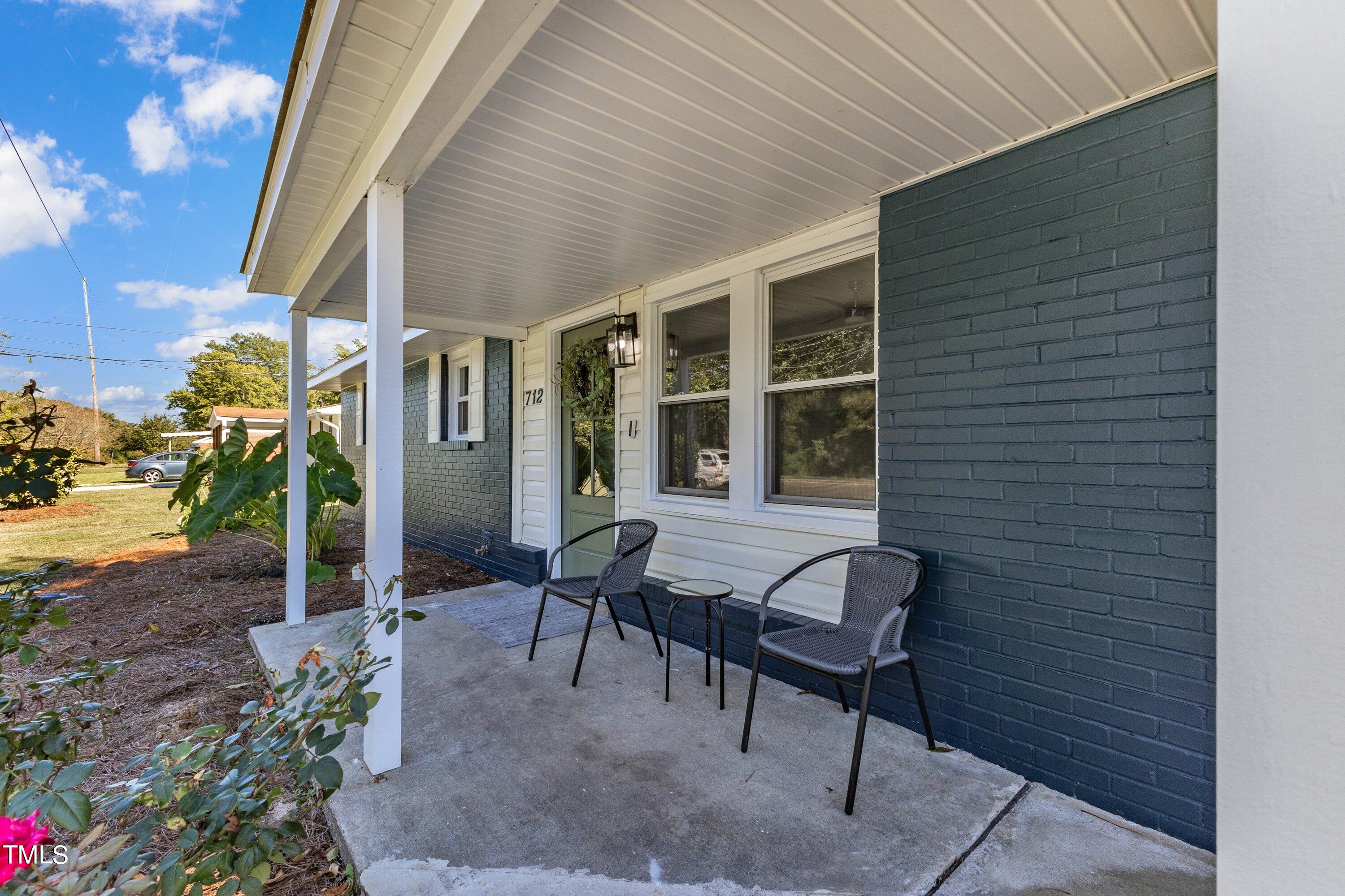 712 Bailey Drive Raleigh, NC 27610 - Photo 5 of 33 a balcony with furniture and potted plants