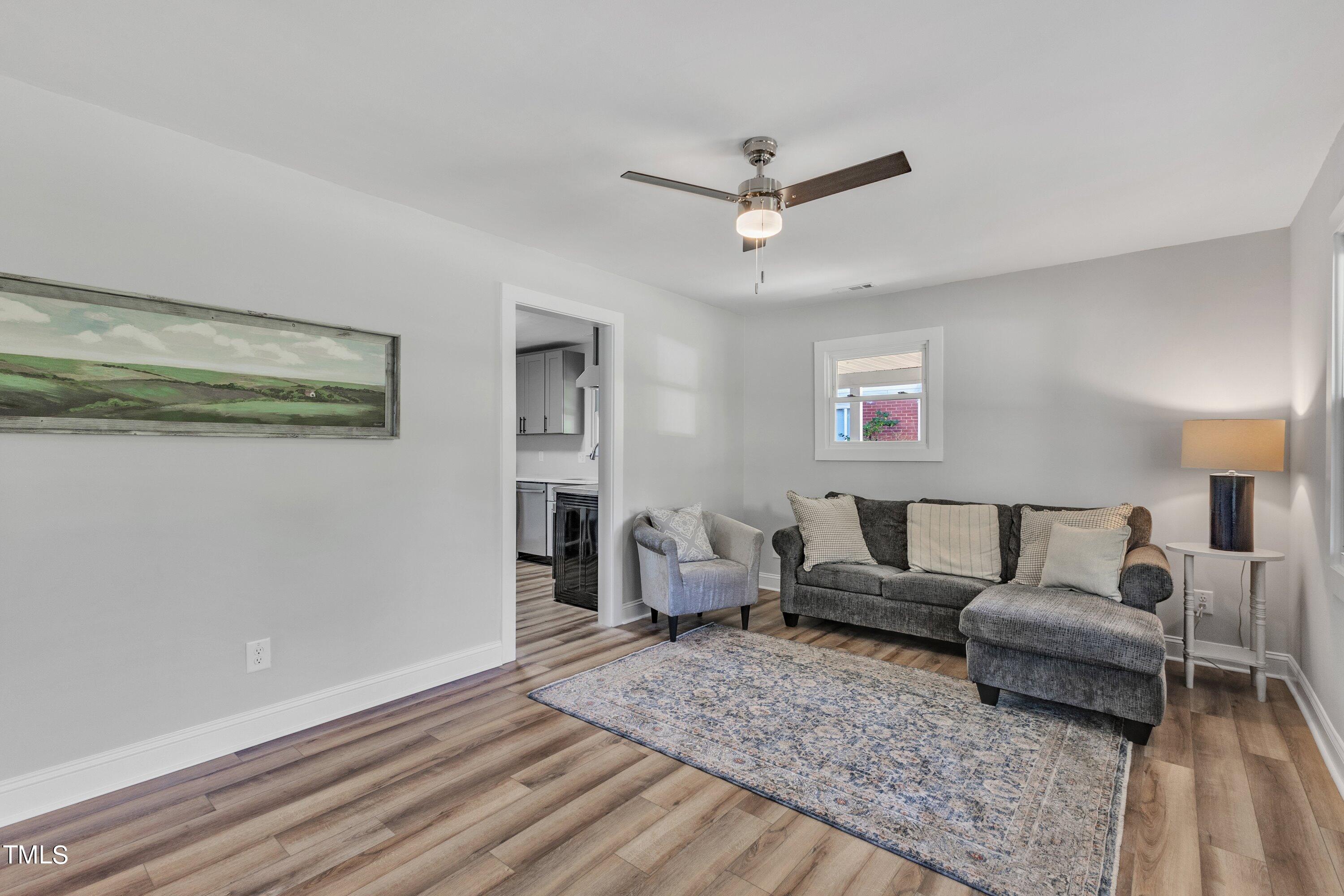 712 Bailey Drive Raleigh, NC 27610 - Photo 6 of 33 a living room with furniture and a wooden floor