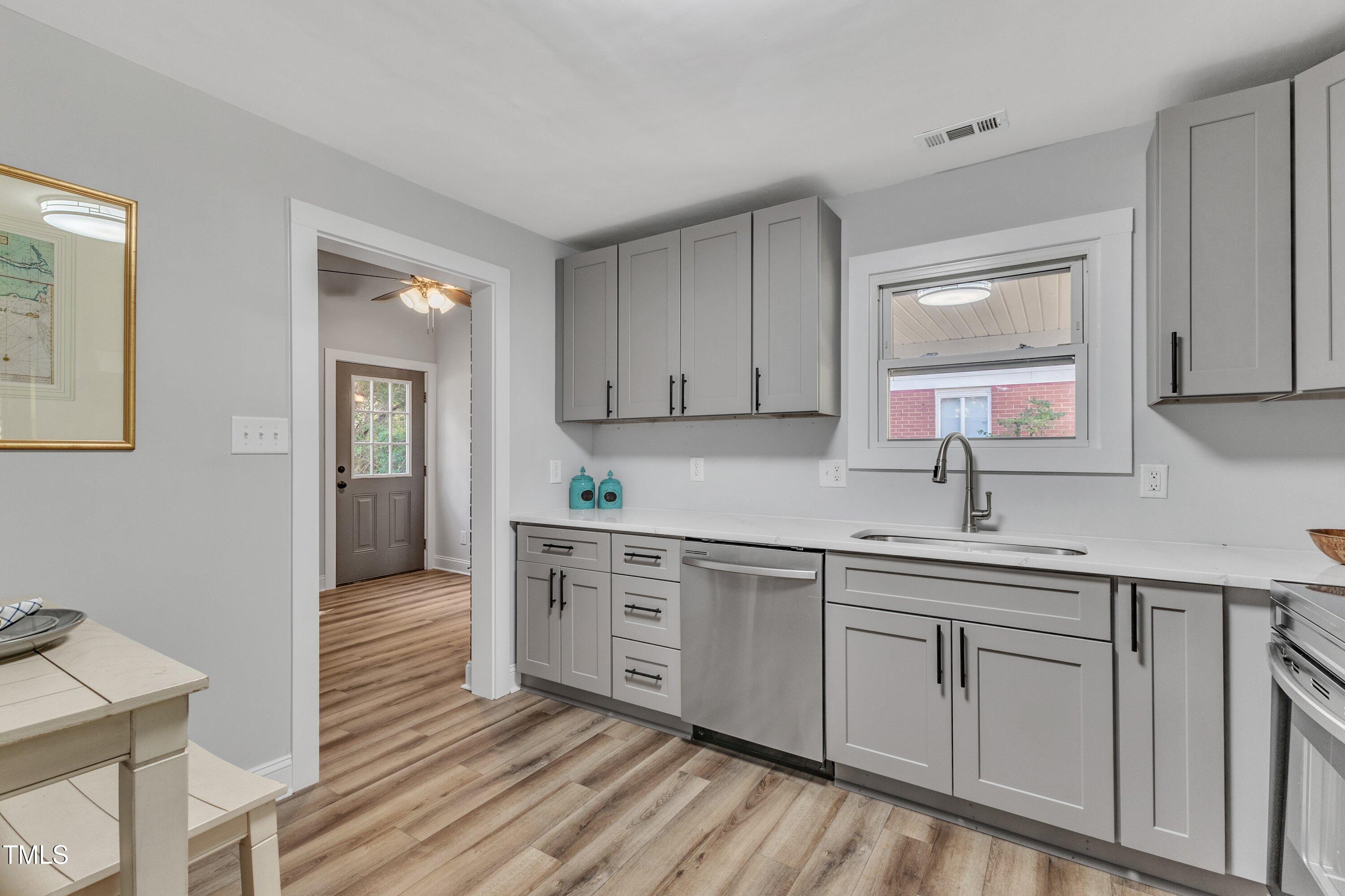 712 Bailey Drive Raleigh, NC 27610 - Photo 9 of 33 a kitchen with white cabinets and sink