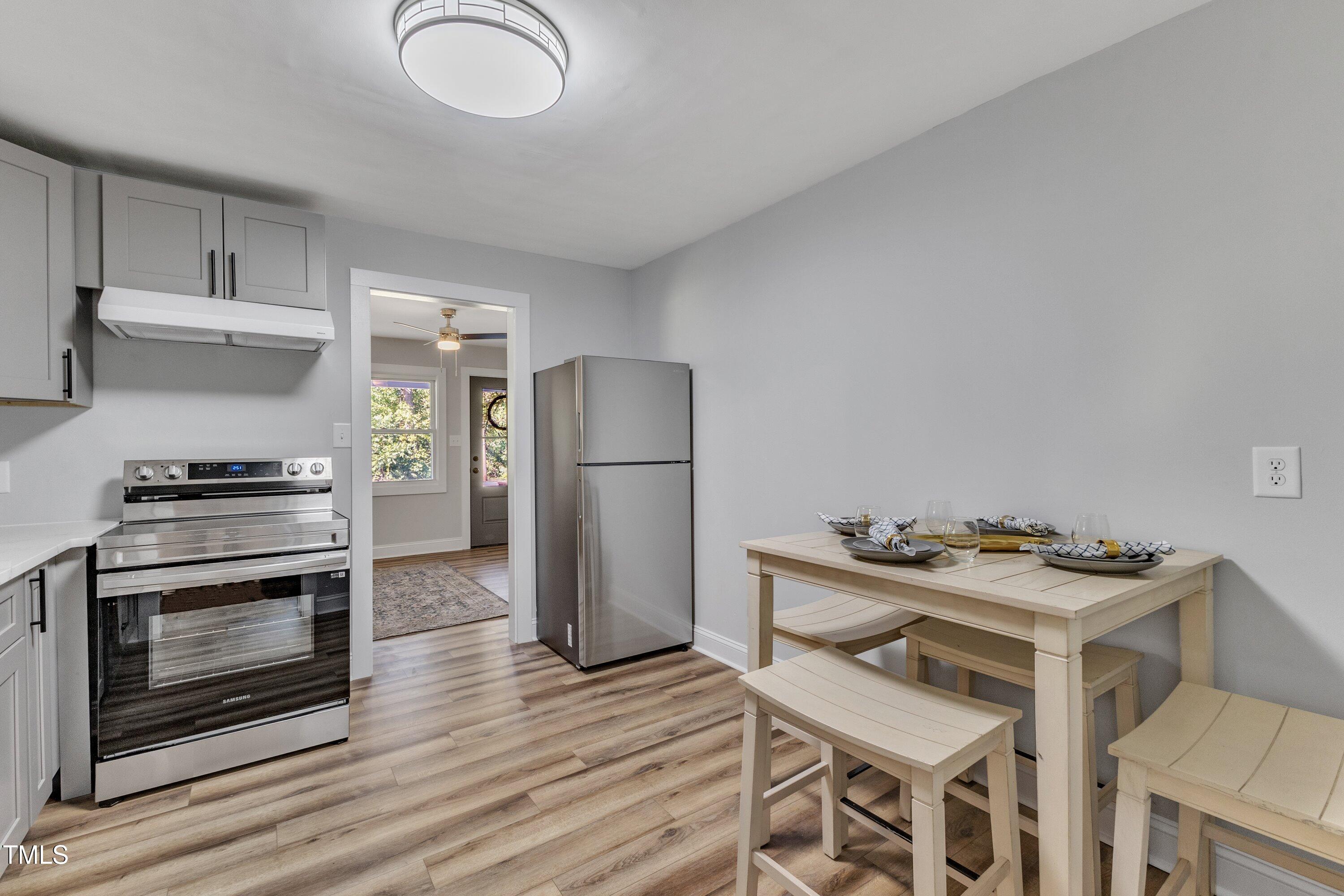 712 Bailey Drive Raleigh, NC 27610 - Photo 10 of 33 a kitchen with stainless steel appliances granite countertop a refrigerator stove and sink