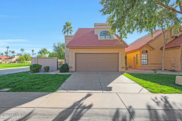 a front view of a house with a yard and a garage