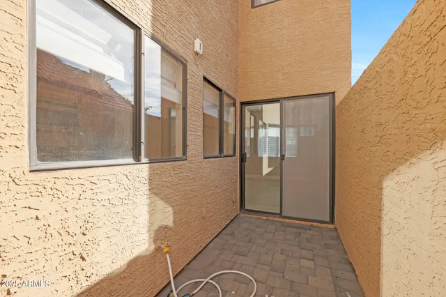 a view of empty room with window and ceiling fan