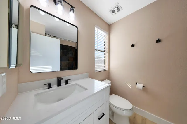 a view of a house with a backyard and plants