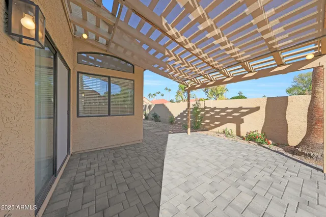 an aerial view of a house with a garden and lake view