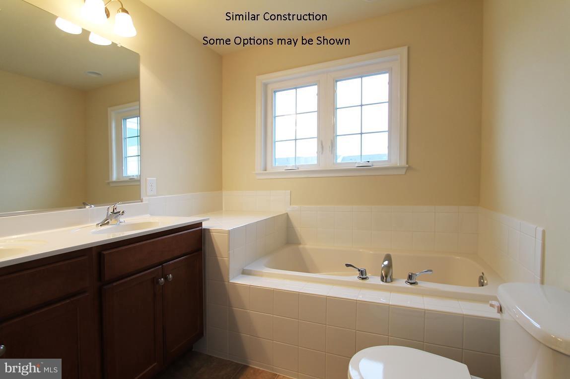 0 Rumbling Rock Road Hedgesville, WV 25427 - Photo 13 of 19 a bathroom with a tub sink toilet and mirror
