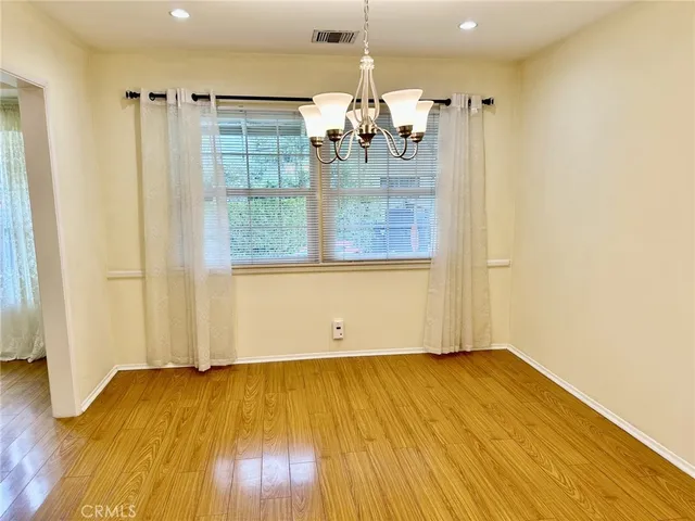 a view of a room with wooden floor and window