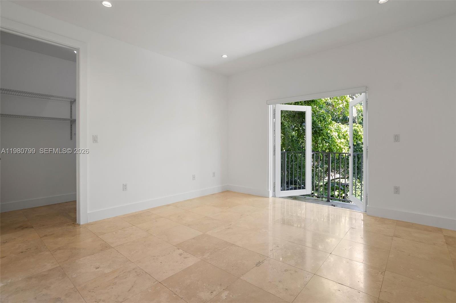 2786 Southwest 34th Avenue Miami, FL 33133 - Photo 16 of 42 an empty room with large windows and garden