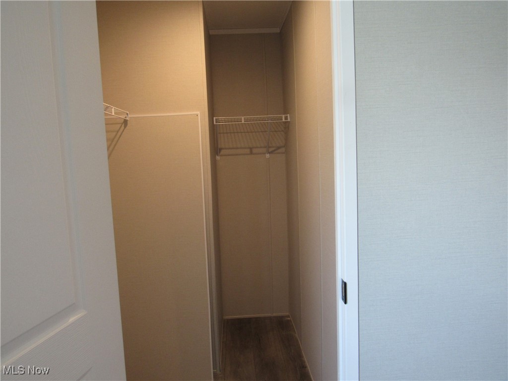 30 Kyle Lane Akron, OH 44310 - Photo 21 of 23 Walk in closet featuring wood-type flooring. Hot water heater is located in here.