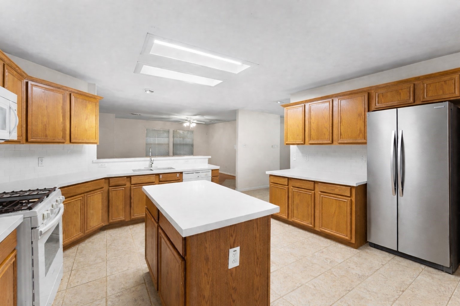 3522 Brackenfern Road Katy, TX 77449 - Photo 9 of 17 a kitchen with stainless steel appliances a refrigerator sink and cabinets