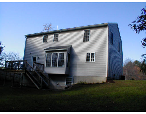 8 Labbe Road Groton, MA 01450 - Photo 8 of 8 a front view of a house with a garden