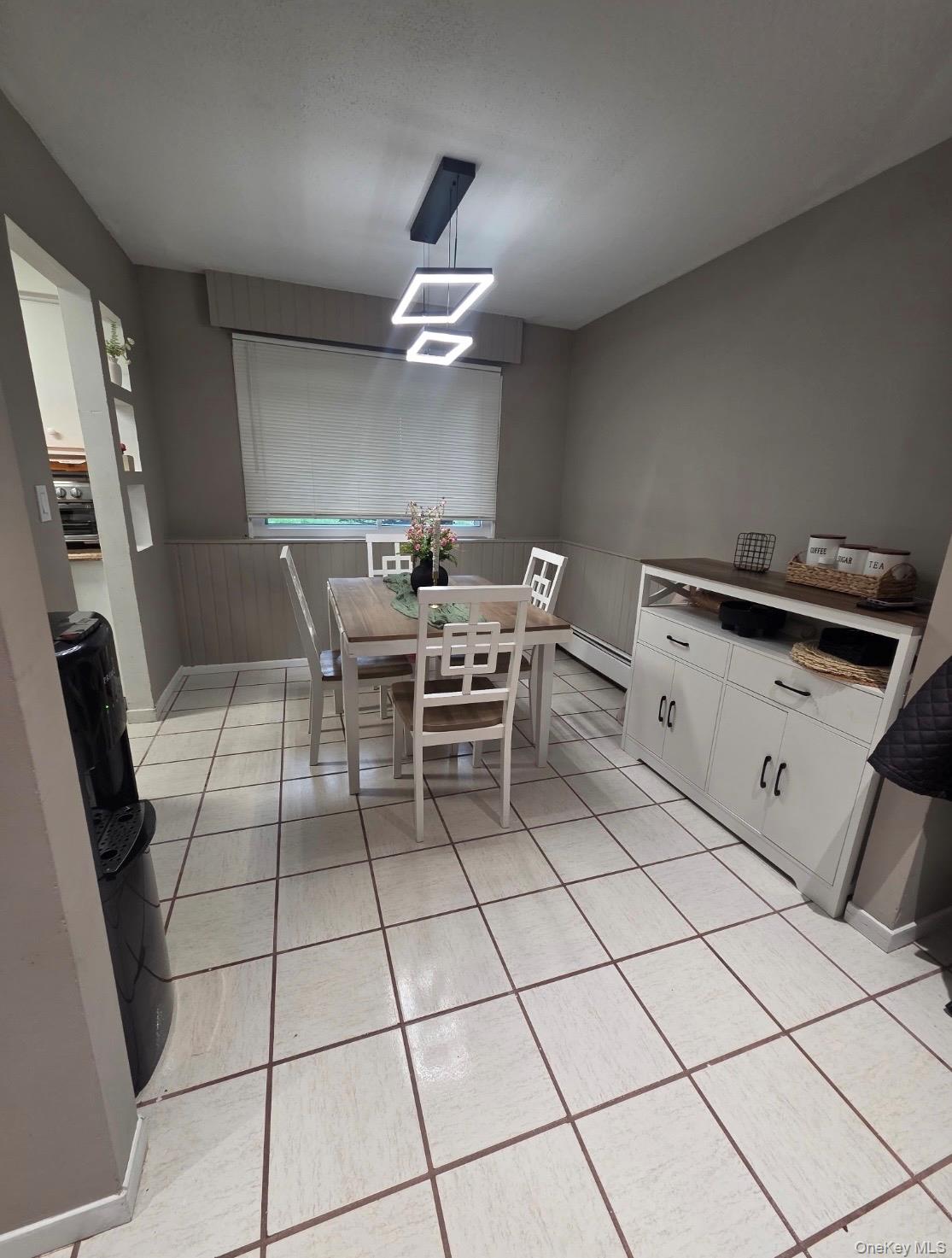 19 Tanager Road, Unit 1902 Monroe, NY 10950 - Photo 2 of 9 a dining room with furniture and a chandelier