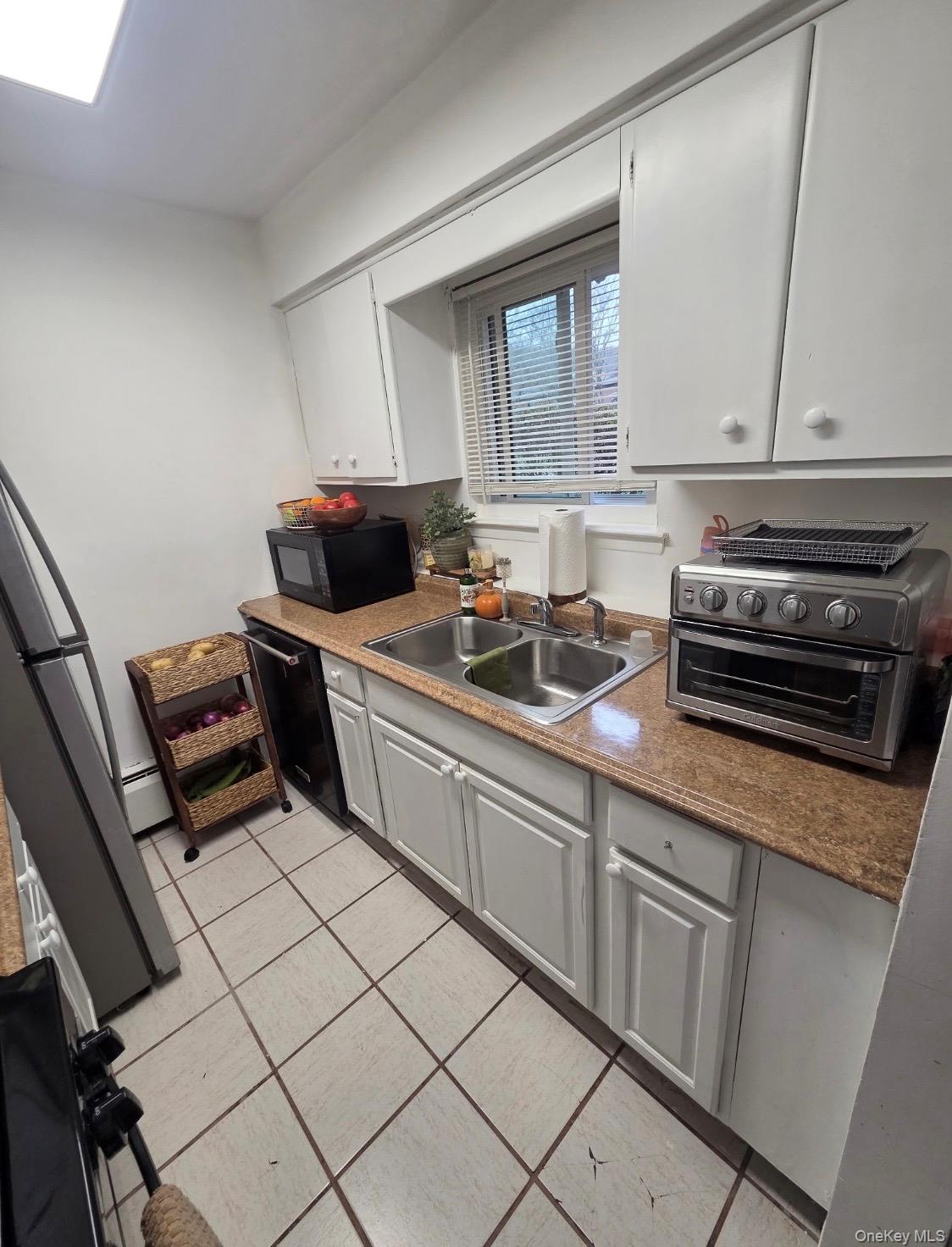 19 Tanager Road, Unit 1902 Monroe, NY 10950 - Photo 3 of 9 a kitchen with a sink appliances and cabinets