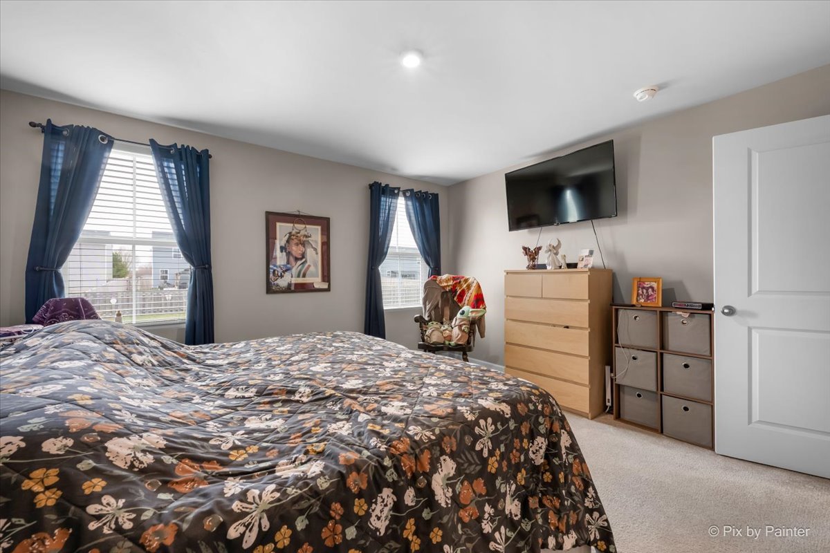 205 North Buckeye Street Waterman, IL 60556 - Photo 10 of 34 a bedroom with a bed and a flat screen tv