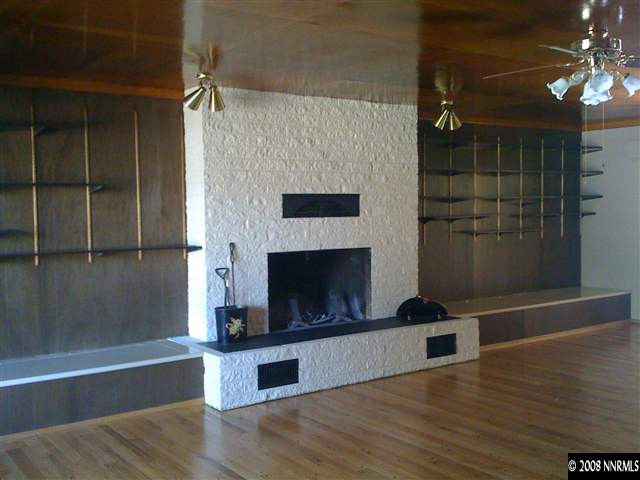 15110 Kivett Lane Reno, NV 89521 - Photo 2 of 9 a living room with stainless steel appliances wooden floor and a fireplace