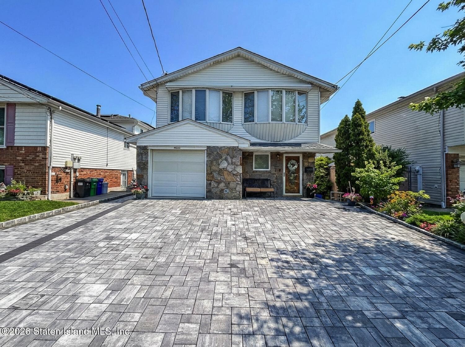 11 Firth Road Staten Island, NY 10314 - Photo 1 of 34 a front view of a house with a yard and garage