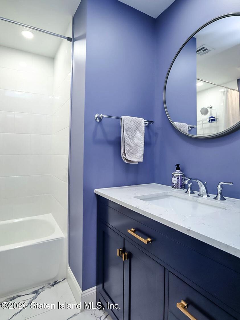 11 Firth Road Staten Island, NY 10314 - Photo 14 of 34 a bathroom with a sink a tub and a mirror