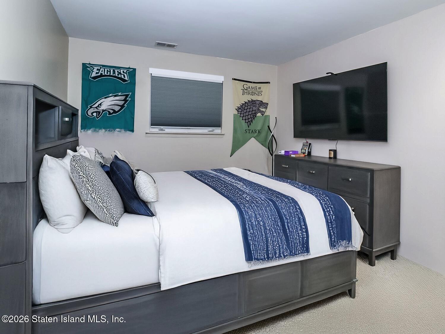 11 Firth Road Staten Island, NY 10314 - Photo 20 of 34 a bedroom with a bed and a flat screen tv