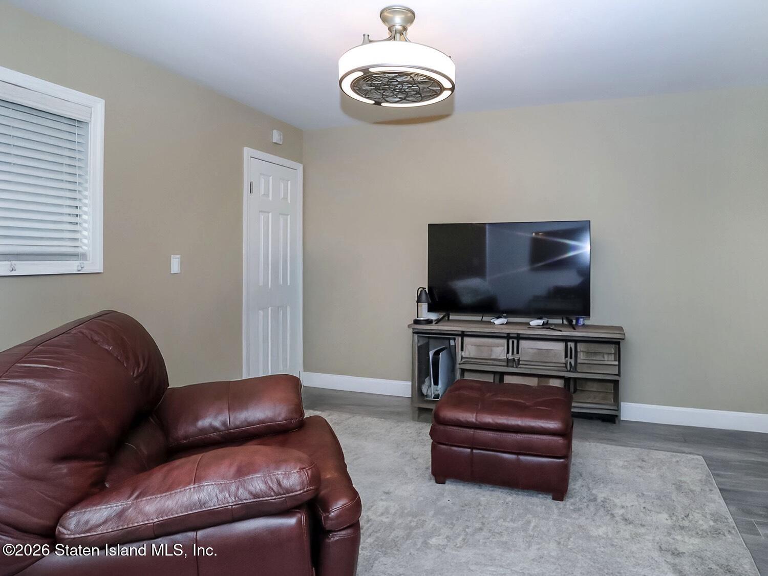 11 Firth Road Staten Island, NY 10314 - Photo 23 of 34 a living room with furniture and a flat screen tv