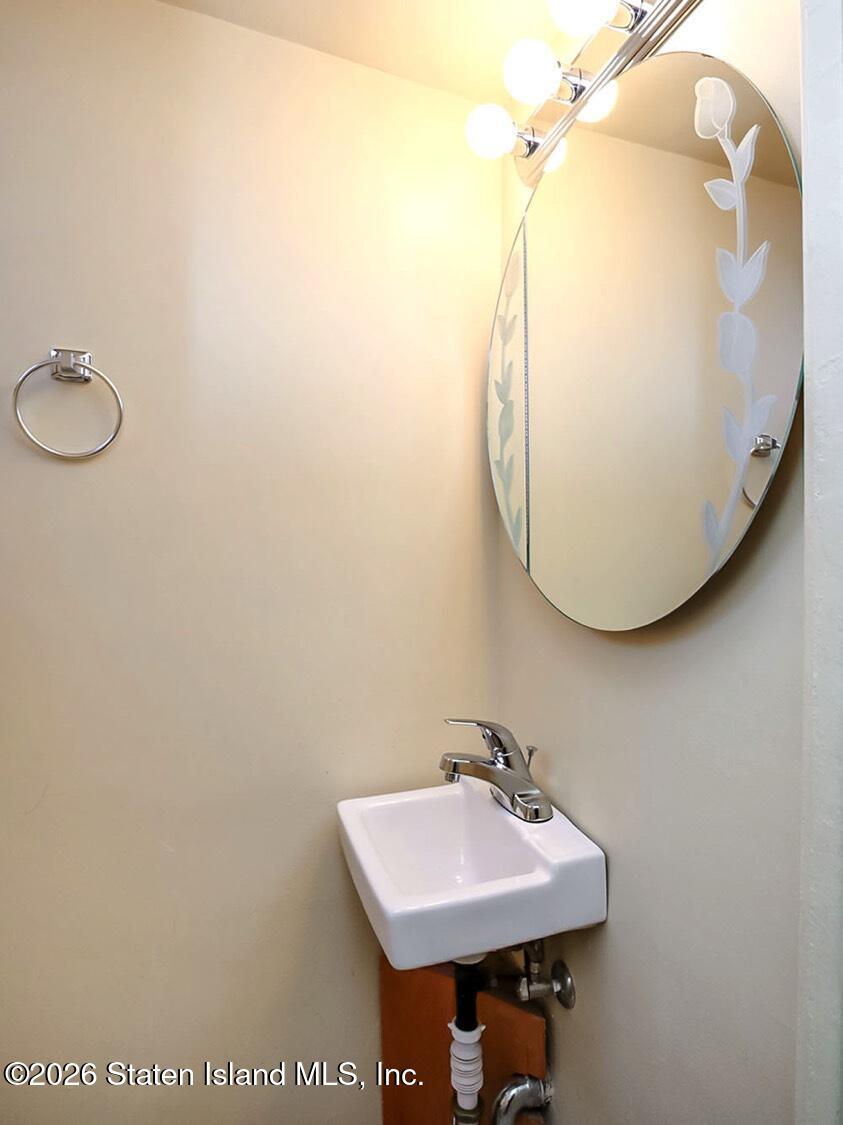11 Firth Road Staten Island, NY 10314 - Photo 24 of 34 a bathroom with a sink and mirror