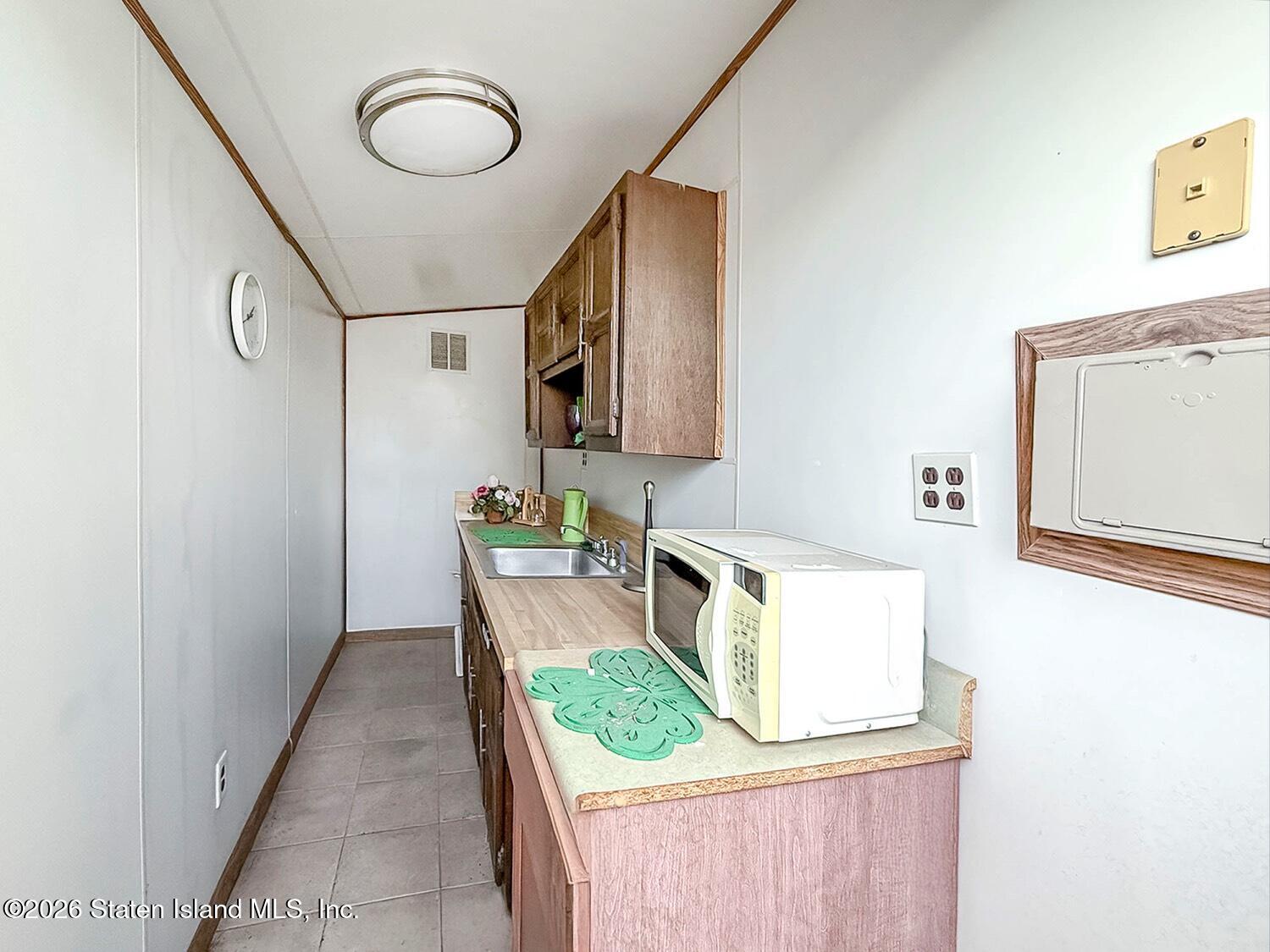 11 Firth Road Staten Island, NY 10314 - Photo 31 of 34 a bathroom with a sink mirror and toilet
