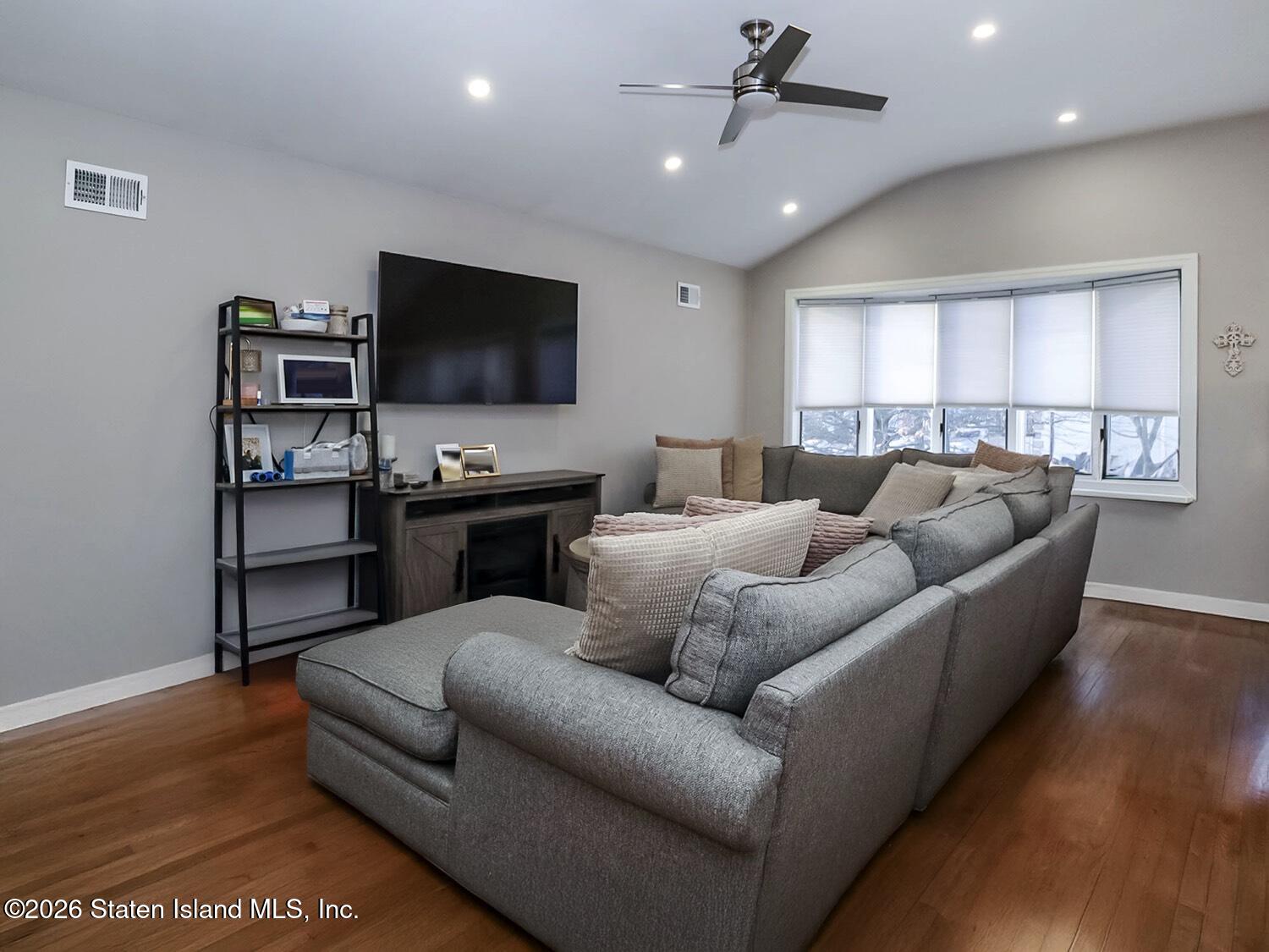 11 Firth Road Staten Island, NY 10314 - Photo 4 of 34 a living room with furniture and a flat screen tv