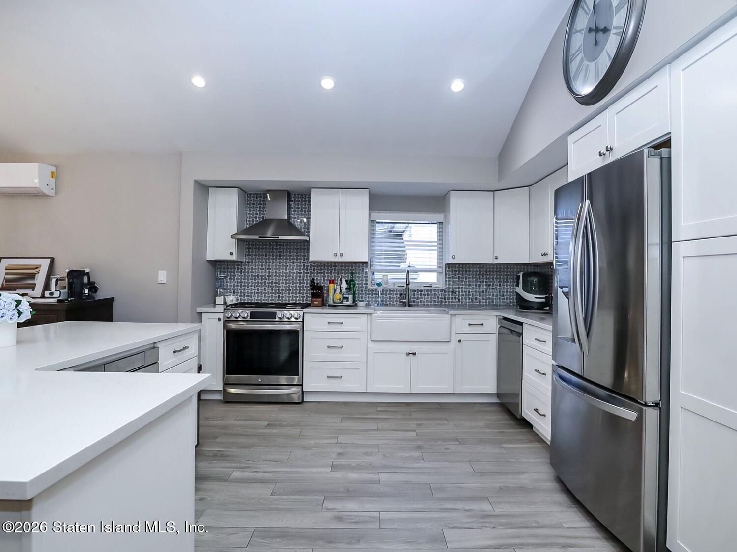 11 Firth Road Staten Island, NY 10314 - Photo 6 of 34 a kitchen with a refrigerator and a stove top oven