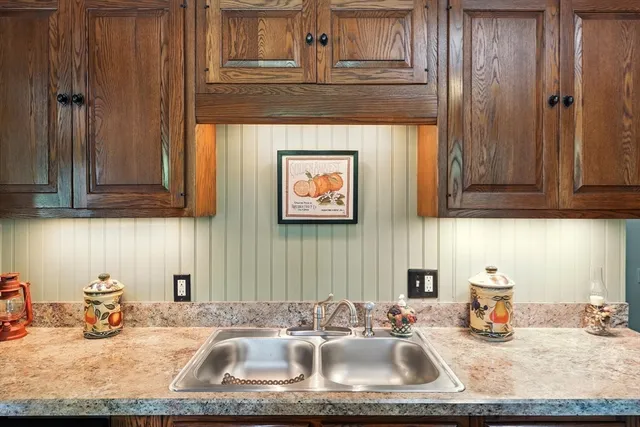 a kitchen with sink and cabinets