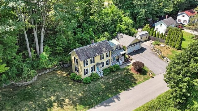 an aerial view of a house with a yard patio and garden