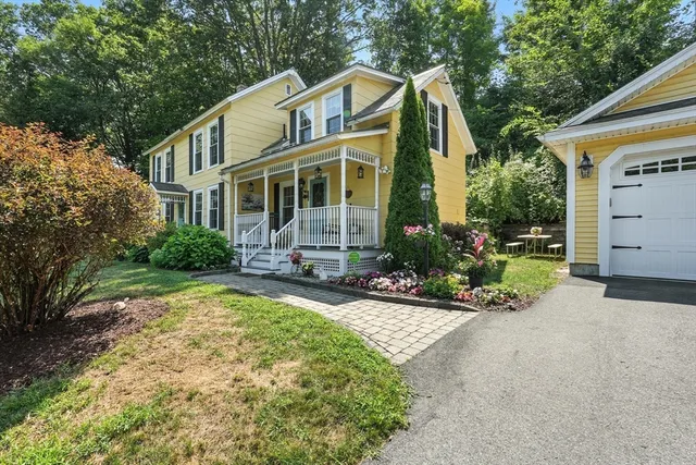 a view of a house with backyard sitting area and garden