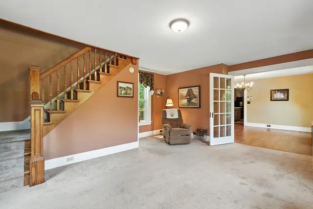 a view of a livingroom with furniture and staircase