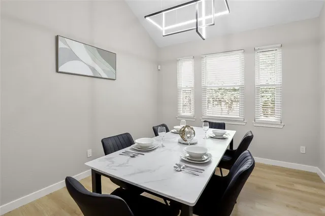 a view of a dining room with furniture and window
