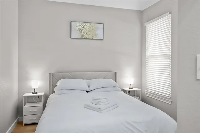 a bedroom with a bed and a window