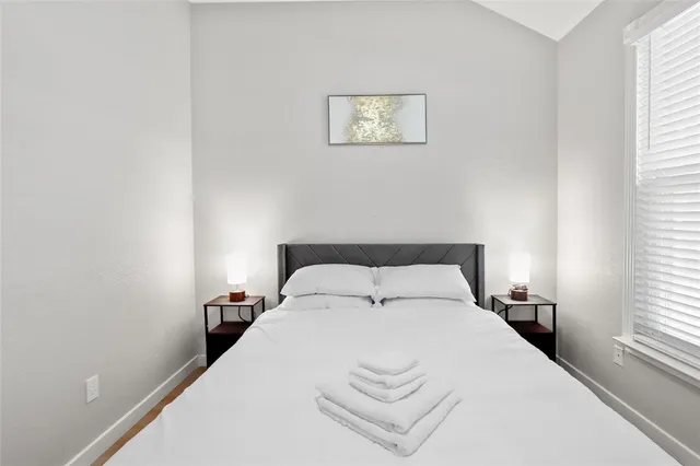 a bedroom with a bed and a window