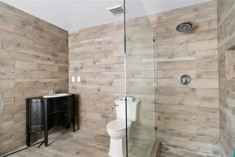 a bathroom with a toilet and a shower