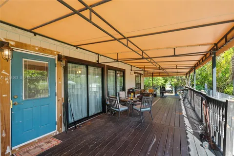 a view of a balcony with chairs and wooden floor