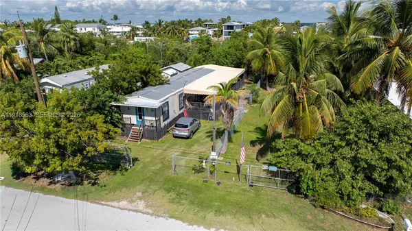 a view of house with swimming pool and furniture