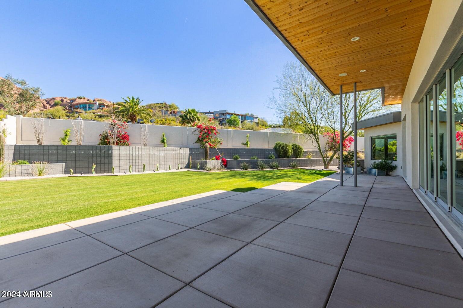 5833 North 46th Street Phoenix, AZ 85018 - Photo 25 of 29 a view of a house with a swimming pool and a yard