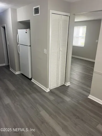 an entryway with wooden floor