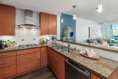 a kitchen with kitchen island granite countertop stainless steel appliances sink stove and cabinets