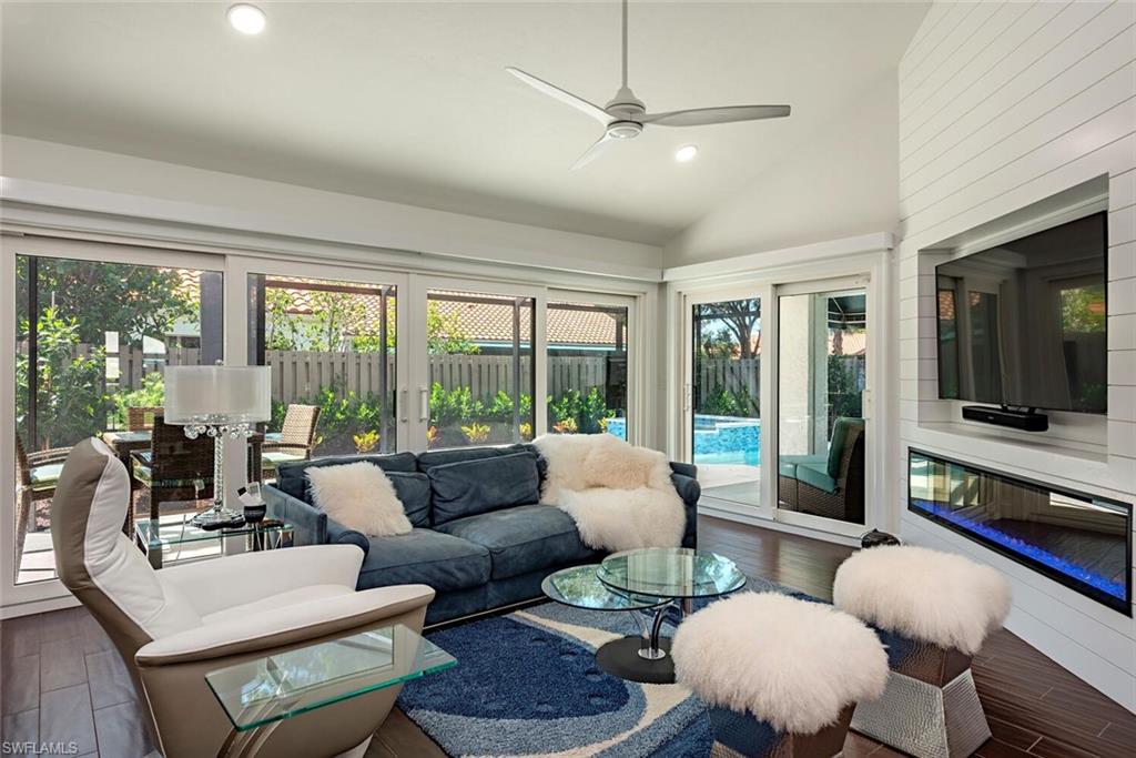 748 Reef Point Circle Naples, FL 34108 - Photo 5 of 23 Living room featuring wood finished floors, plenty of natural light, vaulted ceiling, recessed lighting, and ceiling fan