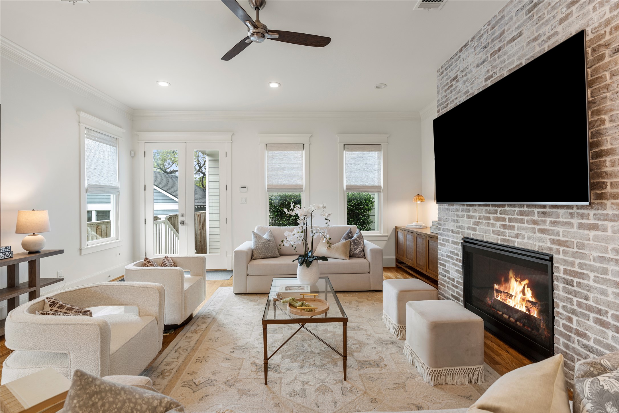 925 Tulane Street, Unit A Houston, TX 77008 - Photo 23 of 49 Gather around the white-washed, floor-to-ceiling brick fireplace, which offers gas and A/V connections.