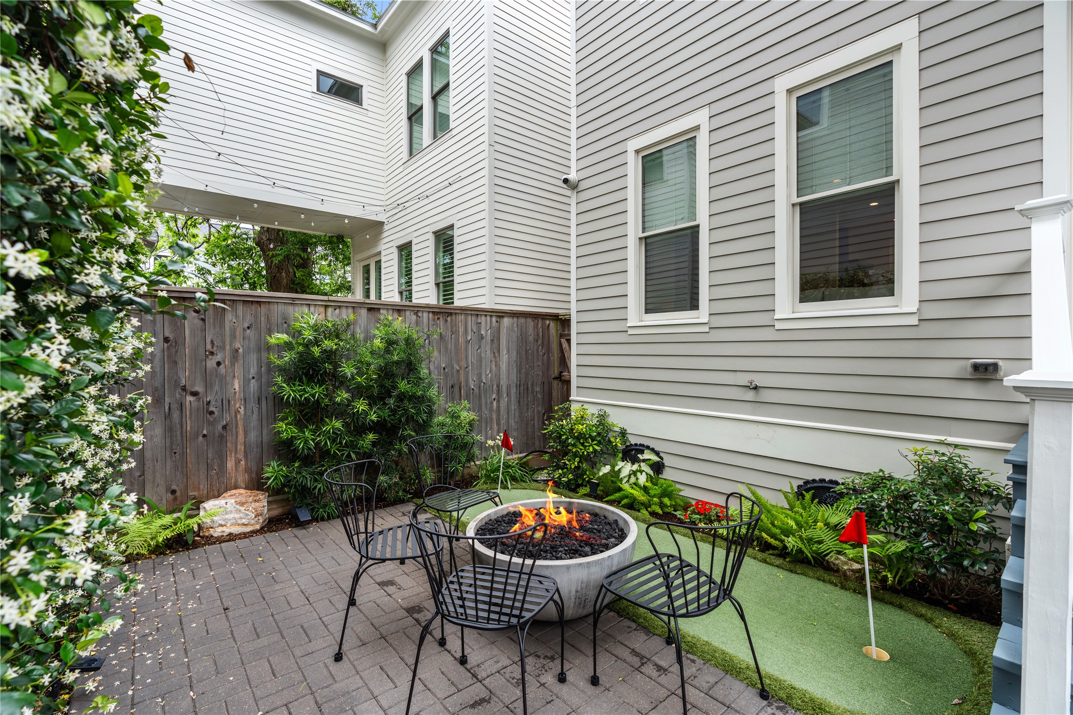 925 Tulane Street, Unit A Houston, TX 77008 - Photo 3 of 49 Enjoy a rare backyard that’s both relaxing and easy to care for, thanks to its putting green, gas fire-pit and Belgard pavers.