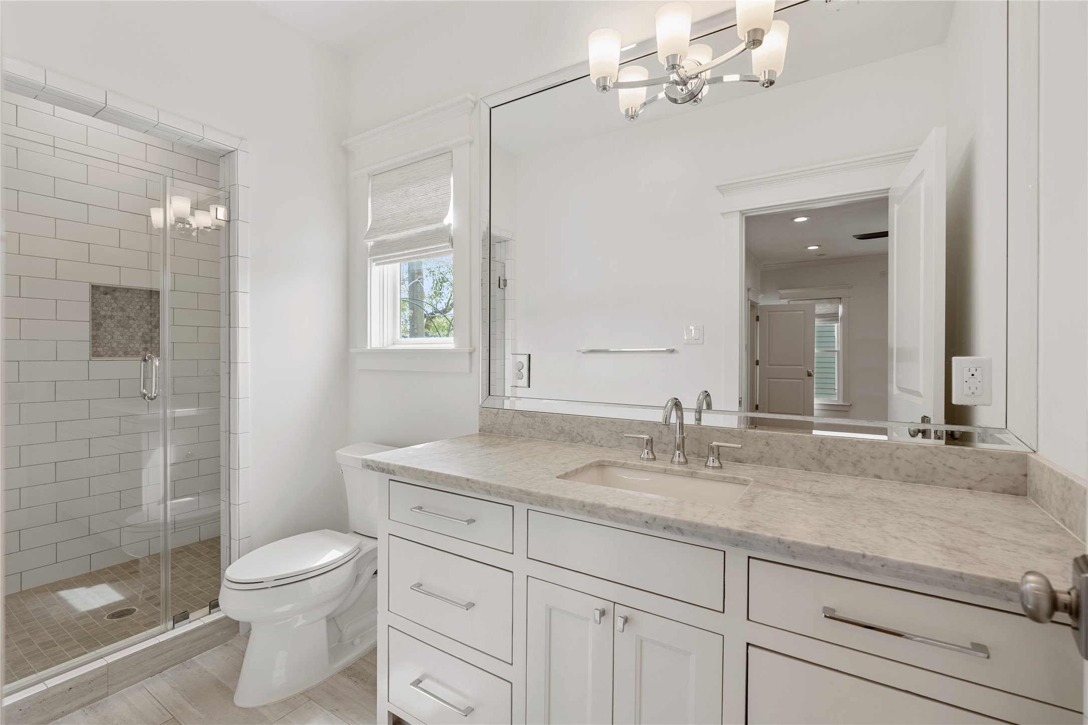 925 Tulane Street, Unit A Houston, TX 77008 - Photo 35 of 49 In this en suite secondary bathroom, you’ll find a bright window, a walk-in shower and a marble vanity.