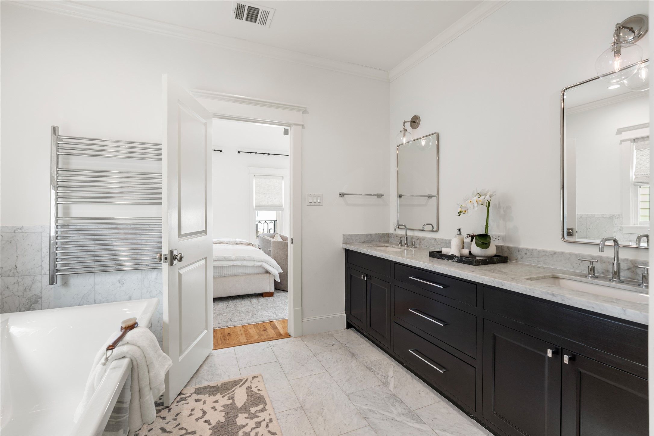 925 Tulane Street, Unit A Houston, TX 77008 - Photo 39 of 49 In the primary bathroom, you’ll enjoy generous counter and cabinet space in the wide double vanity featuring soft-close drawers and cabinets, marble countertops, a custom mirrors and designer lighting.