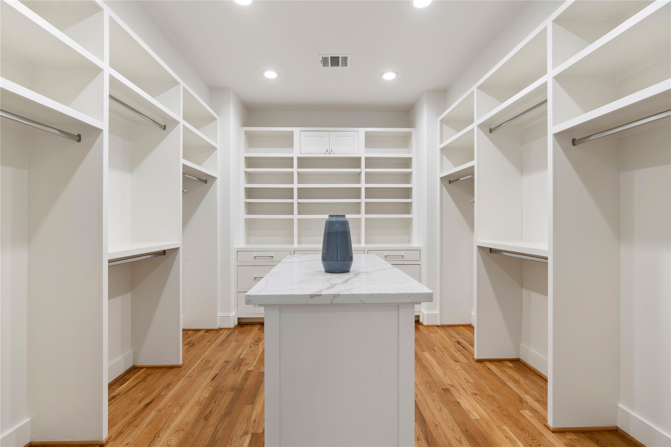 925 Tulane Street, Unit A Houston, TX 77008 - Photo 43 of 49 You’ll never lack wardrobe storage thanks to the primary suite’s phenomenal walk-in closet featuring a double-door entry, a large packing island, and rows of hanging rods and shelving.