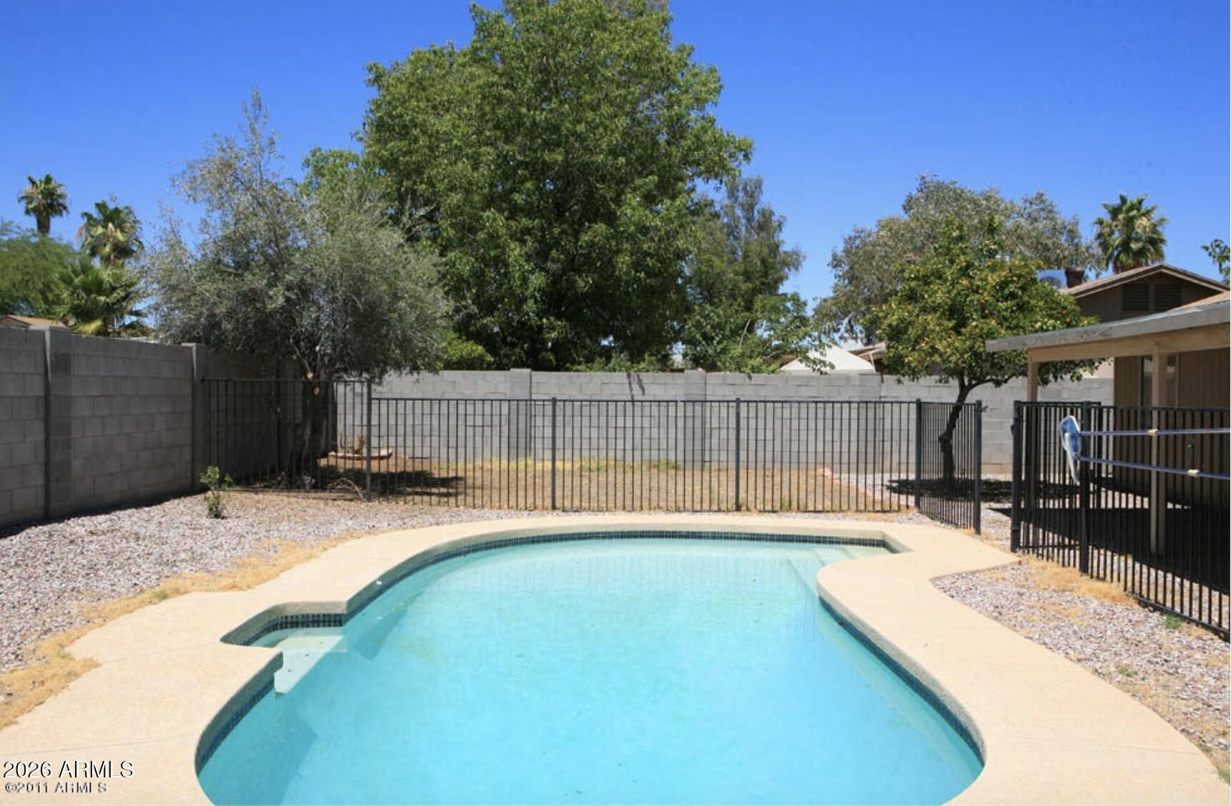 911 West Colgate Drive Tempe, AZ 85283 - Photo 2 of 15 a swimming pool with wooden fence